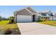 Wide driveway leading to a two-car garage, with well-maintained landscaping at 8077 Fort Hill Way, Myrtle Beach, SC 29579