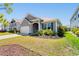 Charming single-story home featuring a well-manicured lawn and inviting front porch at 8077 Fort Hill Way, Myrtle Beach, SC 29579