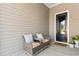 Cozy front porch with seating area, perfect for relaxing and enjoying the neighborhood at 8077 Fort Hill Way, Myrtle Beach, SC 29579