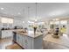 Open floor plan showcases a bright kitchen with granite counters and stainless appliances at 8077 Fort Hill Way, Myrtle Beach, SC 29579