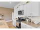 Bright kitchen features granite counters, stainless steel appliances, and white cabinets at 8077 Fort Hill Way, Myrtle Beach, SC 29579