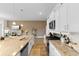 Bright kitchen features granite counters, stainless steel appliances, and white cabinets at 8077 Fort Hill Way, Myrtle Beach, SC 29579