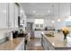 Bright kitchen features granite counters, stainless steel appliances, and white cabinets at 8077 Fort Hill Way, Myrtle Beach, SC 29579