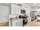 Bright kitchen features granite counters, stainless steel appliances, and white cabinets at 8077 Fort Hill Way, Myrtle Beach, SC 29579