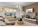 Inviting living room featuring a plush sectional sofa and an entertainment center with a large TV at 8077 Fort Hill Way, Myrtle Beach, SC 29579