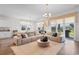 Bright and airy living room with a large sectional sofa and access to the backyard at 8077 Fort Hill Way, Myrtle Beach, SC 29579