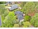 Aerial view of house with fenced backyard, patio, and lush trees at 8209 Timber Ridge Rd., Conway, SC 29526