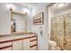Bright bathroom with granite countertops, framed mirror, and a shower/tub combination with curtain at 8209 Timber Ridge Rd., Conway, SC 29526