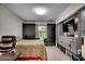 Modern bedroom with built-in wardrobes, a comfortable bed, and a wall-mounted TV for relaxation at 8209 Timber Ridge Rd., Conway, SC 29526