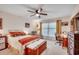 Comfortable bedroom featuring a ceiling fan, large window, and a spacious layout with a work desk at 8209 Timber Ridge Rd., Conway, SC 29526