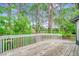 Wooden deck with white railings overlooking scenic lush greenery, trees, and the golf course at 8209 Timber Ridge Rd., Conway, SC 29526