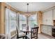 Cozy dining area featuring a round table, decorative chandelier, and large windows for natural lighting at 8209 Timber Ridge Rd., Conway, SC 29526