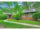 Charming brick home featuring a well-maintained lawn and a welcoming curved walkway at 8209 Timber Ridge Rd., Conway, SC 29526