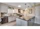 A modern kitchen featuring white cabinetry, an island with gray countertop, and stainless steel appliances at 8209 Timber Ridge Rd., Conway, SC 29526