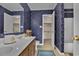 Bathroom with dual sinks and floral wallpaper, and a shower-tub combo at 829 9Th Ave. S, North Myrtle Beach, SC 29582