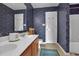 Bathroom with dual sinks and floral wallpaper, and a shower-tub combo at 829 9Th Ave. S, North Myrtle Beach, SC 29582