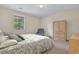 Bright bedroom showcasing a queen bed with decorative bedding, and a closet with a dresser at 829 9Th Ave. S, North Myrtle Beach, SC 29582