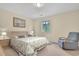 Cozy bedroom featuring a comfortable bed, natural light from the window, and a relaxing armchair at 829 9Th Ave. S, North Myrtle Beach, SC 29582