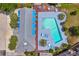 Aerial view of a community pool with lounge chairs and tables on wooden decking at 829 9Th Ave. S, North Myrtle Beach, SC 29582