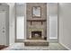 Close-up of a fireplace with a wooden mantle and hearth, flanked by windows at 829 9Th Ave. S, North Myrtle Beach, SC 29582