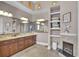 Luxurious bathroom featuring double sinks, granite countertops, and a fireplace at 837 Bluff View Dr., Myrtle Beach, SC 29579