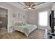 Inviting bedroom with a tray ceiling, light-colored walls and a decorative ceiling fan at 837 Bluff View Dr., Myrtle Beach, SC 29579