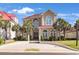 Stately two-story home boasting a stucco facade, elegant arched windows, and lush palm trees enhancing its curb appeal at 837 Bluff View Dr., Myrtle Beach, SC 29579