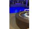 Close-up of a modern fire pit next to the pool for cozy evenings at 837 Bluff View Dr., Myrtle Beach, SC 29579