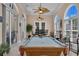 This luxurious game room has a pool table, comfortable seating, and views of the outdoors at 837 Bluff View Dr., Myrtle Beach, SC 29579