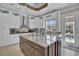 Beautiful kitchen features granite counters, stainless steel appliances, and large island with seating and backyard views at 837 Bluff View Dr., Myrtle Beach, SC 29579
