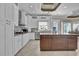 Contemporary kitchen showcasing white cabinets, stainless appliances, and a granite island with seating area at 837 Bluff View Dr., Myrtle Beach, SC 29579