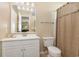 Simple bathroom featuring a single vanity, toilet, shower with curtain, and large mirror at 8796 Cloister Dr. # B, Surfside Beach, SC 29575
