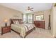 Comfortable bedroom features a ceiling fan, dresser, nightstand, and windows for natural light at 8796 Cloister Dr. # B, Surfside Beach, SC 29575
