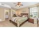 Inviting bedroom showcasing a closet, nightstand, ceiling fan, and a window for ample lighting at 8796 Cloister Dr. # B, Surfside Beach, SC 29575