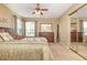 Sunlit bedroom features a mirrored closet, dresser, and a ceiling fan for added comfort at 8796 Cloister Dr. # B, Surfside Beach, SC 29575
