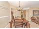 Cozy dining room featuring a wooden table, chandelier, and access to the living area at 8796 Cloister Dr. # B, Surfside Beach, SC 29575