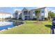 Beautiful condominium exterior featuring a serene pond and well-maintained landscaping at 8796 Cloister Dr. # B, Surfside Beach, SC 29575
