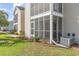 An exterior view of the property showing the patio, landscaping, and part of the lawn at 8796 Cloister Dr. # B, Surfside Beach, SC 29575