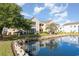 Exterior view of the property showing the lake, landscaping, and screened-in porch at 8796 Cloister Dr. # B, Surfside Beach, SC 29575