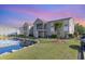 Beautiful condominium exterior featuring a serene pond and well-maintained landscaping at 8796 Cloister Dr. # B, Surfside Beach, SC 29575
