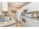 Compact kitchen featuring white appliances, granite countertops, and ample cabinet space at 8796 Cloister Dr. # B, Surfside Beach, SC 29575