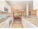 The kitchen offers granite countertops and white appliances, open to the dining area at 8796 Cloister Dr. # B, Surfside Beach, SC 29575