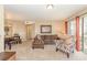 Comfortable living area with a brown sofa, patterned chair, and sliding glass doors to the outside at 8796 Cloister Dr. # B, Surfside Beach, SC 29575