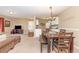 Cozy living room and dining area with neutral tones, plush carpet, and a view to the kitchen at 8796 Cloister Dr. # B, Surfside Beach, SC 29575