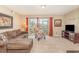 Inviting living room featuring cozy seating, decor, a TV and sliding glass doors with pond views at 8796 Cloister Dr. # B, Surfside Beach, SC 29575