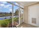 This screened porch features table and chairs with water views and access to a pond at 8796 Cloister Dr. # B, Surfside Beach, SC 29575