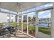 This screened porch features table and chairs with water views and access to a pond at 8796 Cloister Dr. # B, Surfside Beach, SC 29575
