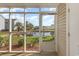 This screened porch features table and chairs with water views and access to a pond at 8796 Cloister Dr. # B, Surfside Beach, SC 29575