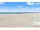 Expansive beach with soft sand and tranquil ocean waters under a clear sky at 9550 Shore Dr. # 226, Myrtle Beach, SC 29572