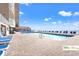Outdoor pool area with lounge chairs overlooks the ocean from a building with multiple stories at 9550 Shore Dr. # 226, Myrtle Beach, SC 29572